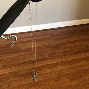 Long silver necklace with turquoise charms and crosses